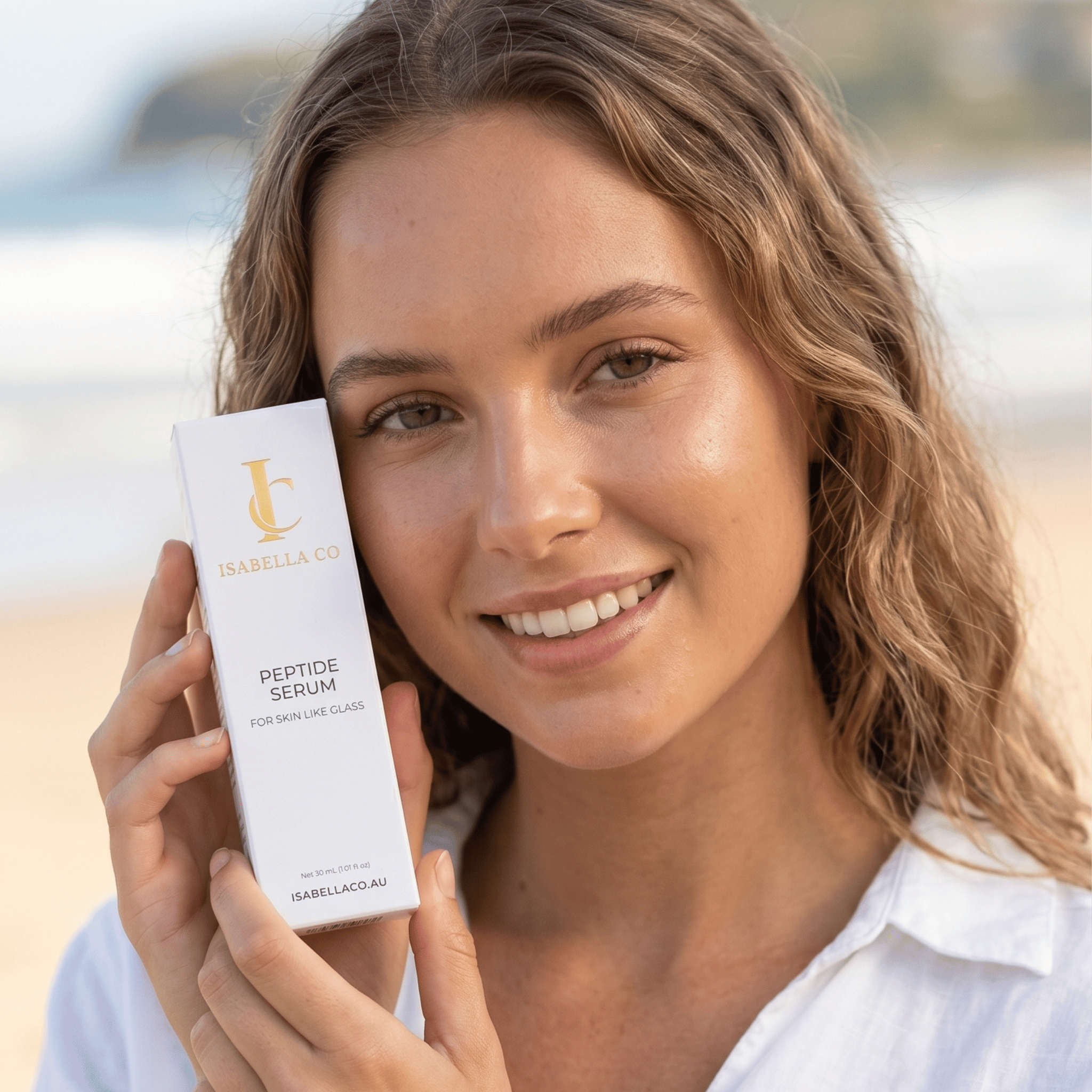 Model with Isabella Co Peptide Serum at beach